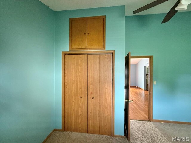 710 Ash St, Greenville, IL 62246 - unfurnished bedroom featuring carpet floors, a closet, baseboards, and a ceiling fan