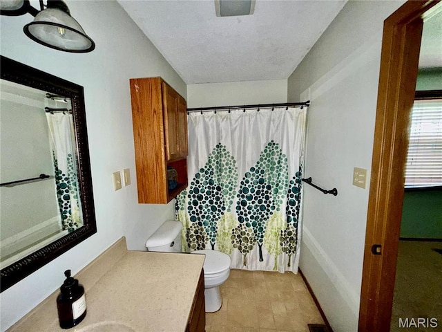 710 Ash St, Greenville, IL 62246 - bathroom featuring toilet, vanity, curtained shower, and baseboards