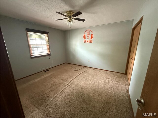 710 Ash St, Greenville, IL 62246 - empty room featuring light colored carpet, a textured ceiling, a ceiling fan, and baseboards