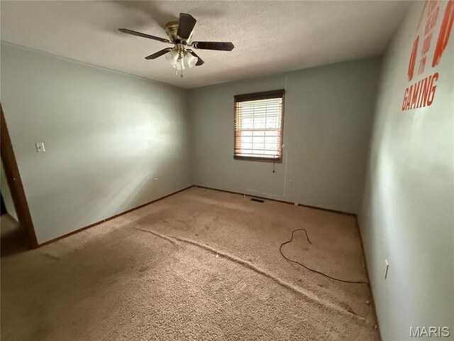 710 Ash St, Greenville, IL 62246 - spare room with a ceiling fan, baseboards, and light colored carpet