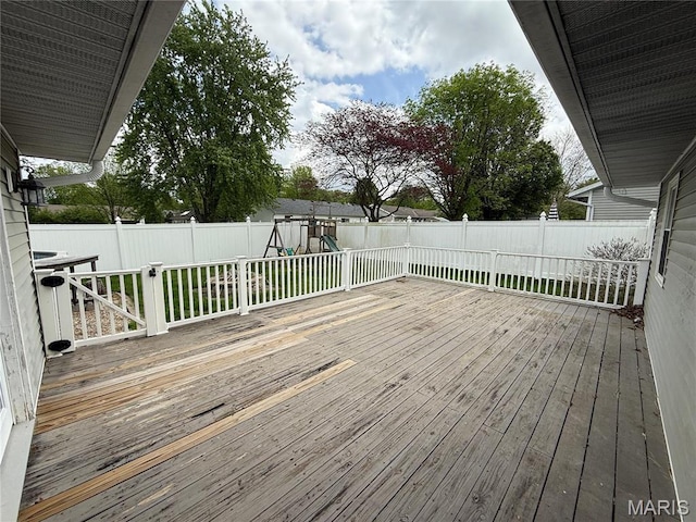 710 Ash St, Greenville, IL 62246 - wooden deck with a fenced backyard and a playground