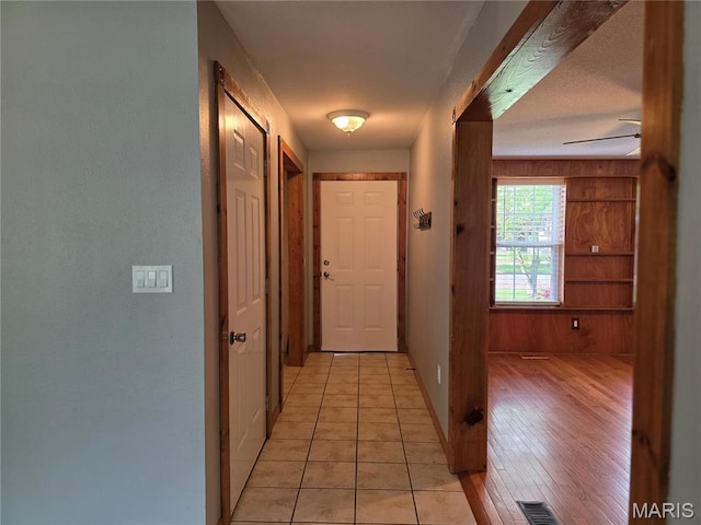 306 Edna Ln, Sparta, IL 62286 - hall featuring wooden walls, baseboards, and light tile patterned flooring