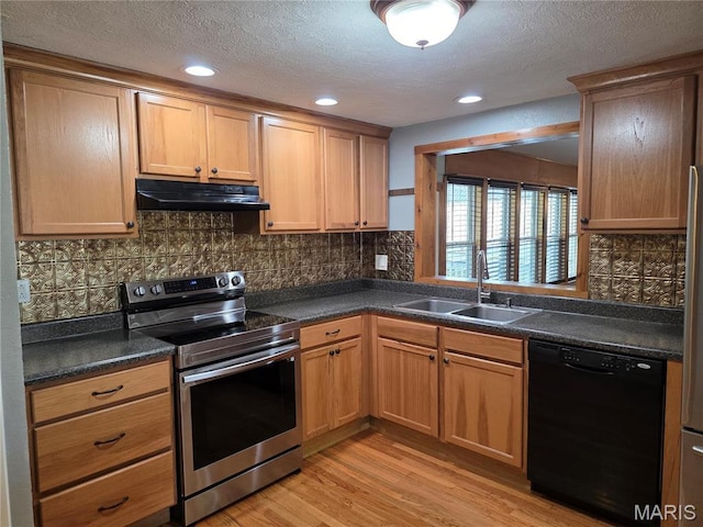 306 Edna Ln, Sparta, IL 62286 - kitchen featuring stainless steel electric stove, black dishwasher, a sink, under cabinet range hood, and dark countertops