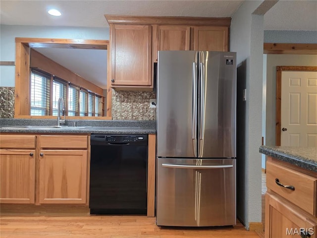 306 Edna Ln, Sparta, IL 62286 - kitchen with freestanding refrigerator, dishwasher, dark countertops, light wood finished floors, and recessed lighting