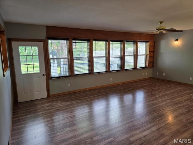 306 Edna Ln, Sparta, IL 62286 - empty room with wood finished floors, ceiling fan, and baseboards