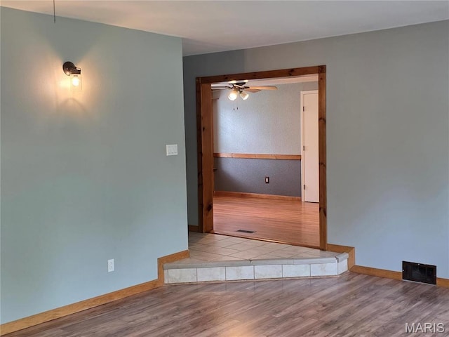 306 Edna Ln, Sparta, IL 62286 - empty room with baseboards, wood finished floors, and a ceiling fan