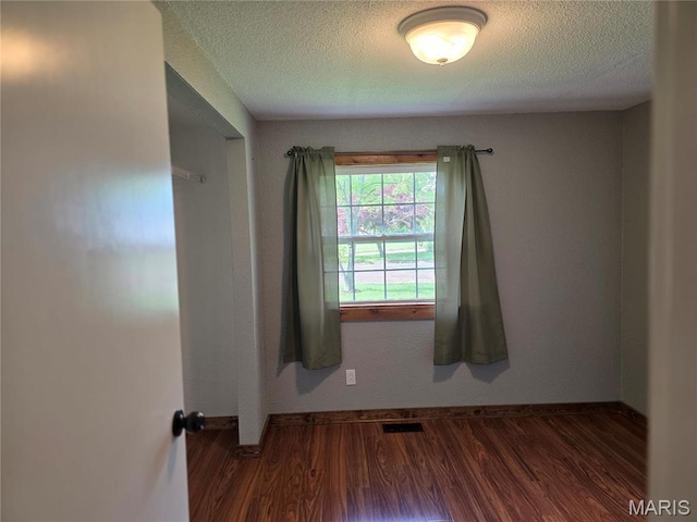 306 Edna Ln, Sparta, IL 62286 - empty room featuring baseboards, wood finished floors, and a textured ceiling
