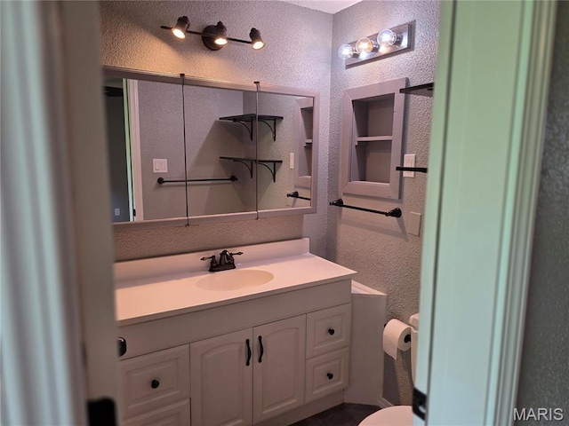 306 Edna Ln, Sparta, IL 62286 - bathroom with a textured wall, vanity, and toilet