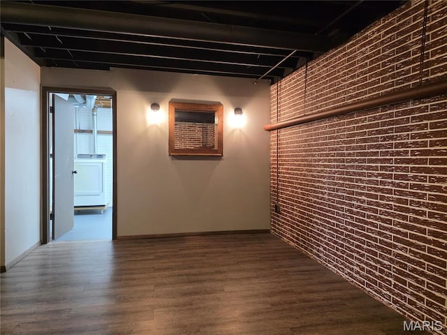 306 Edna Ln, Sparta, IL 62286 - corridor with washer / dryer, brick wall, dark wood finished floors, and baseboards