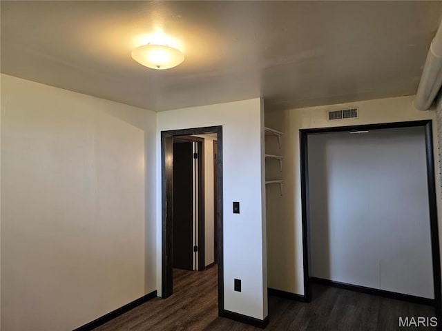 306 Edna Ln, Sparta, IL 62286 - unfurnished bedroom with dark wood finished floors and baseboards