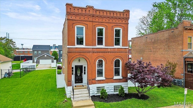 italianate-style house with brick siding, a detached garage, and driveway