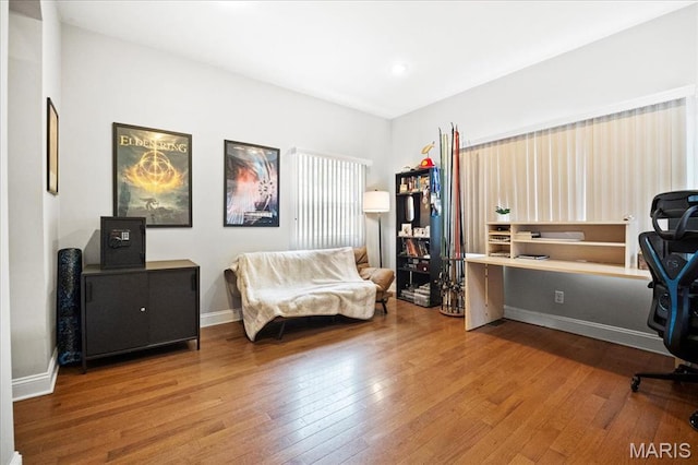 home office with hardwood / wood-style floors and baseboards