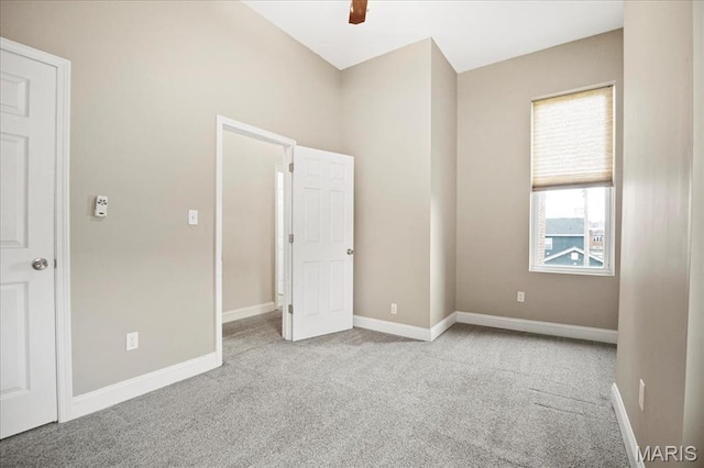 unfurnished bedroom with carpet floors, baseboards, and a ceiling fan