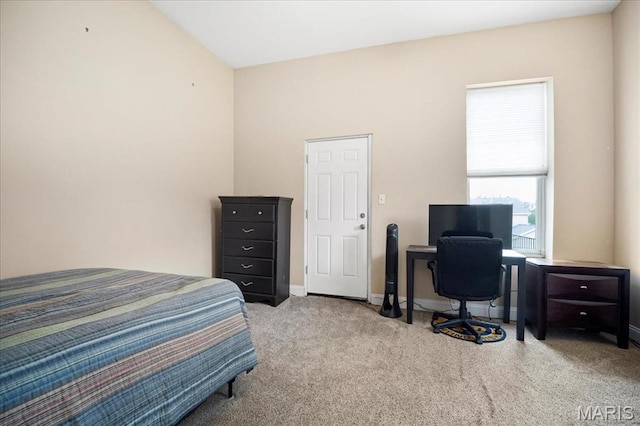 carpeted bedroom featuring baseboards