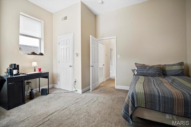 carpeted bedroom with baseboards and an office area