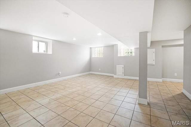 basement with light tile patterned floors, recessed lighting, and baseboards