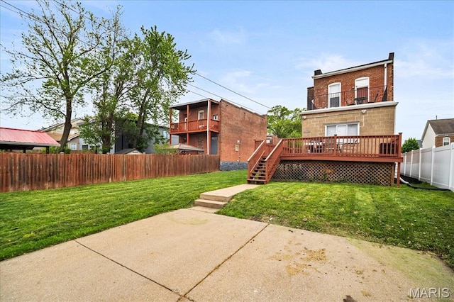 back of house with a deck, a patio area, stairs, and brick siding