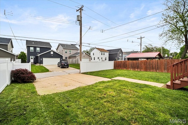 view of yard with a residential view and a garage