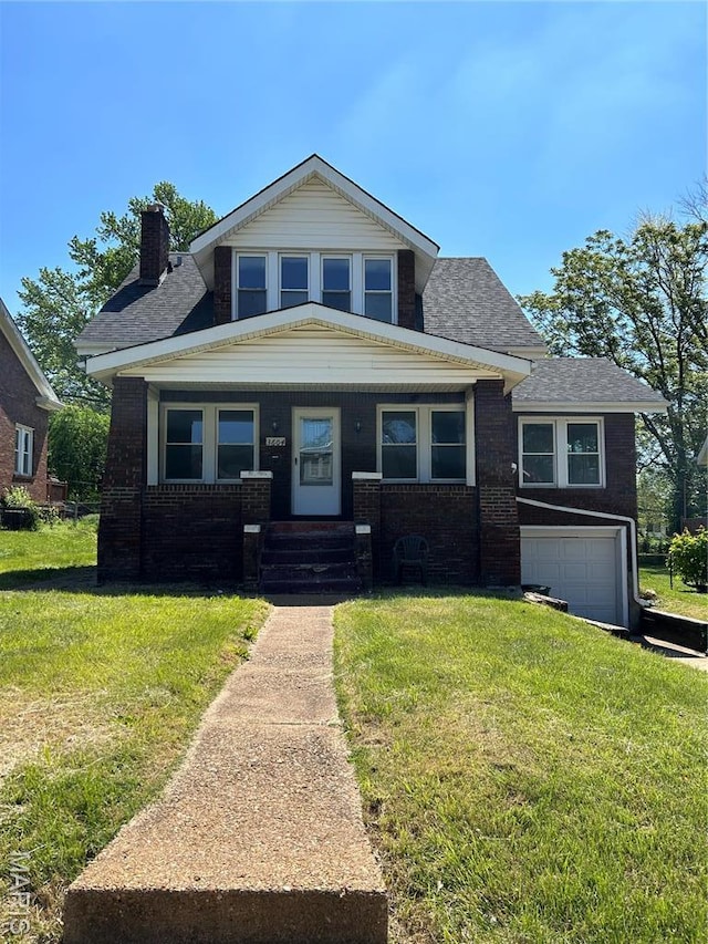 3604 Ridgedale Ave, Saint Louis, MO 63121 - bungalow-style house with a chimney, brick siding, a front yard, and an attached garage