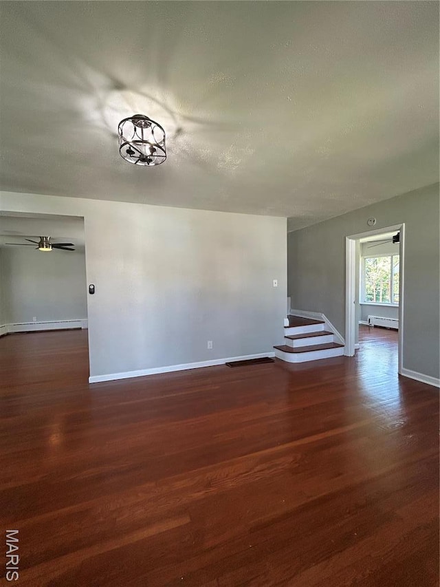 3604 Ridgedale Ave, Saint Louis, MO 63121 - empty room with dark wood-style floors, baseboards, and a baseboard heating unit
