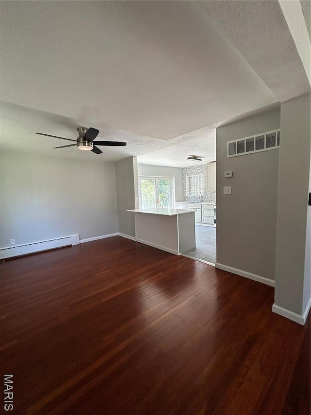 3604 Ridgedale Ave, Saint Louis, MO 63121 - unfurnished room with baseboard heating, baseboards, dark wood-type flooring, and ceiling fan