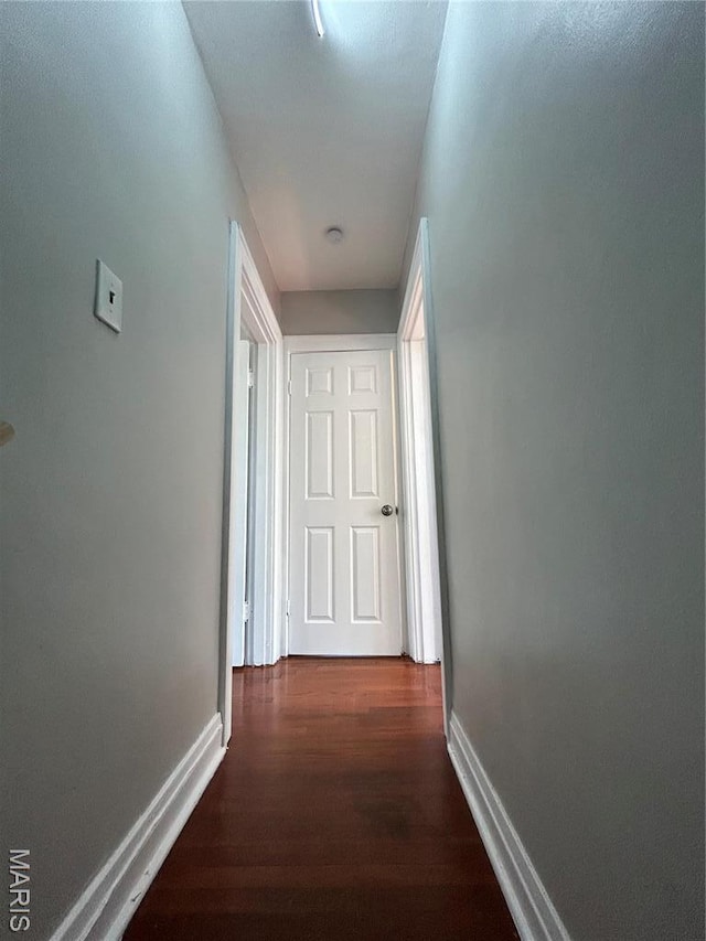 3604 Ridgedale Ave, Saint Louis, MO 63121 - hallway with dark wood-style floors and baseboards