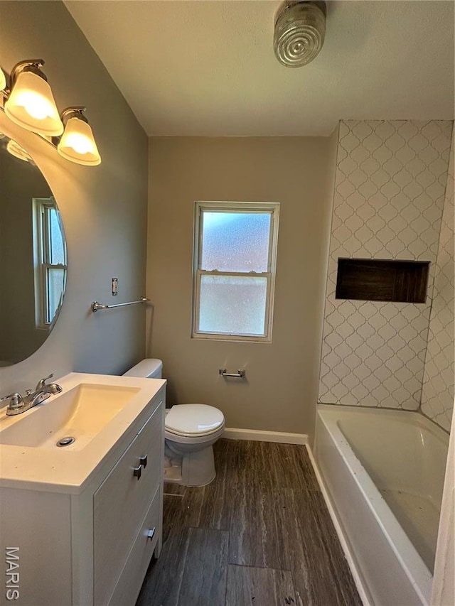 3604 Ridgedale Ave, Saint Louis, MO 63121 - bathroom with wood finished floors, toilet, vanity, and baseboards