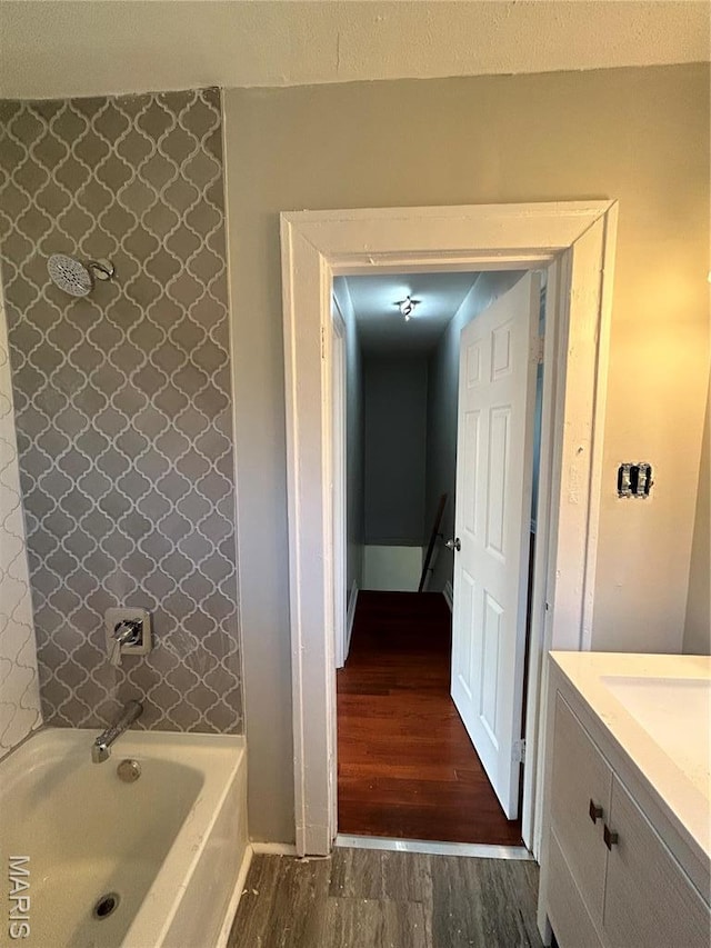 3604 Ridgedale Ave, Saint Louis, MO 63121 - bathroom with wood finished floors, a tub, a shower, vanity, and baseboards