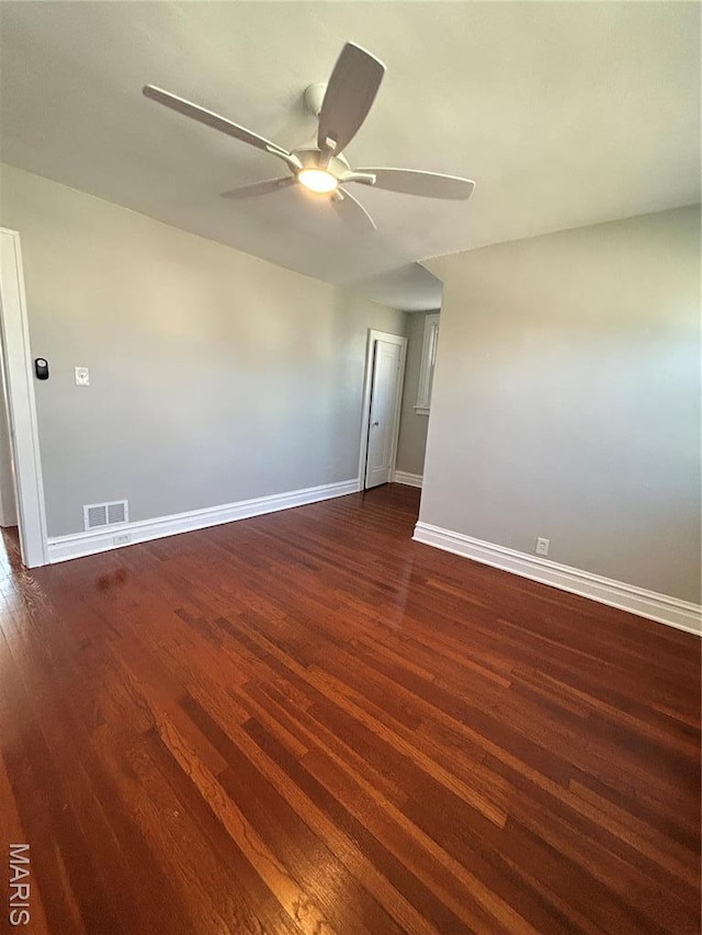 3604 Ridgedale Ave, Saint Louis, MO 63121 - spare room featuring dark wood-type flooring, a ceiling fan, and baseboards