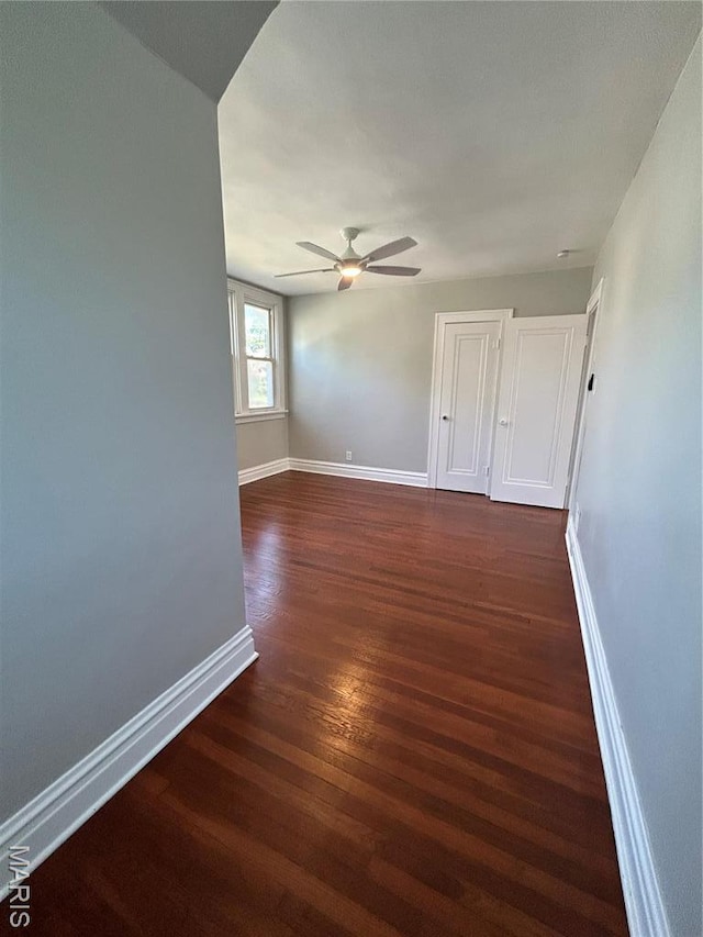 3604 Ridgedale Ave, Saint Louis, MO 63121 - spare room featuring dark wood-type flooring, baseboards, and ceiling fan