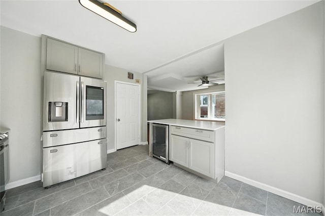 3604 Ridgedale Ave, Saint Louis, MO 63121 - kitchen featuring stainless steel fridge with ice dispenser, wine cooler, light countertops, a ceiling fan, and gray cabinetry