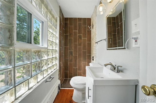 3604 Ridgedale Ave, Saint Louis, MO 63121 - full bath featuring a tile shower, vanity, and wood finished floors