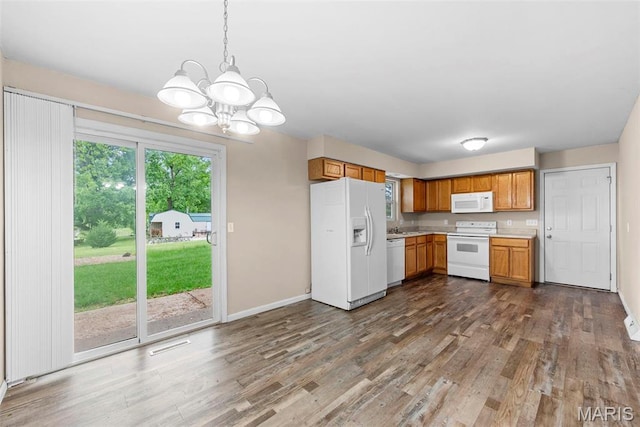 210 Scenic Dr, Elsberry, MO 63343 - kitchen featuring white appliances, a chandelier, light countertops, wood finished floors, and baseboards