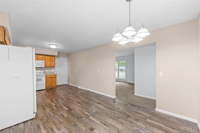 210 Scenic Dr, Elsberry, MO 63343 - kitchen with white appliances, a chandelier, baseboards, and dark wood-type flooring