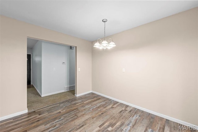 210 Scenic Dr, Elsberry, MO 63343 - unfurnished room featuring baseboards, wood finished floors, and a chandelier