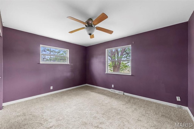 210 Scenic Dr, Elsberry, MO 63343 - spare room with healthy amount of natural light, carpet flooring, a ceiling fan, and baseboards