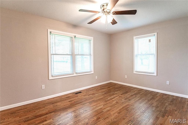 415 W James Blvd, St James, MO 65559 - unfurnished room with a ceiling fan, dark wood-style floors, and baseboards