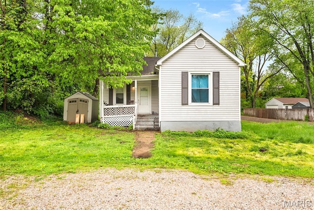 view of front of property with a shed, a porch, and an outbuilding