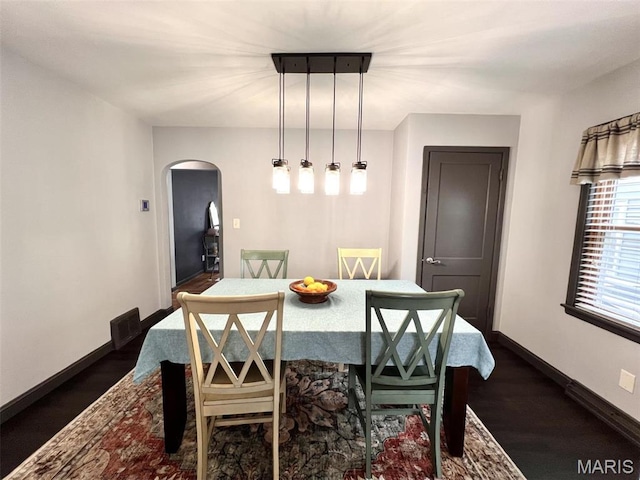 1816 N 22nd St, Springfield, IL 62702 - dining space featuring arched walkways, baseboards, and dark wood-type flooring