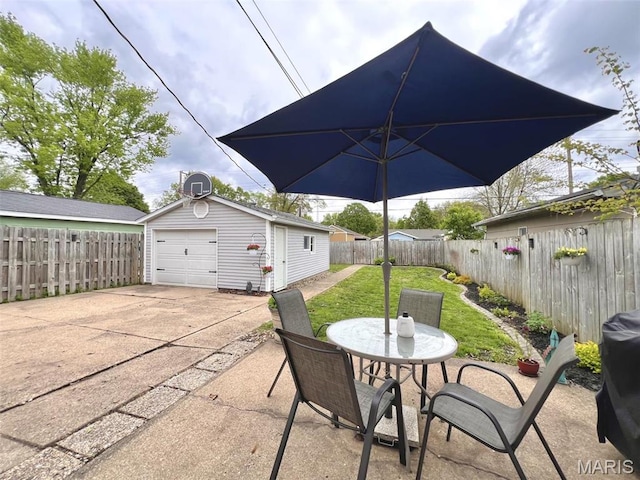 1816 N 22nd St, Springfield, IL 62702 - view of patio featuring an outdoor structure, a garage, outdoor dining space, and driveway