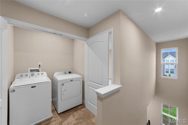 317 Newbridge Way, Ofallon, MO 63368 - laundry area with washing machine and clothes dryer, plenty of natural light, and wood finished floors