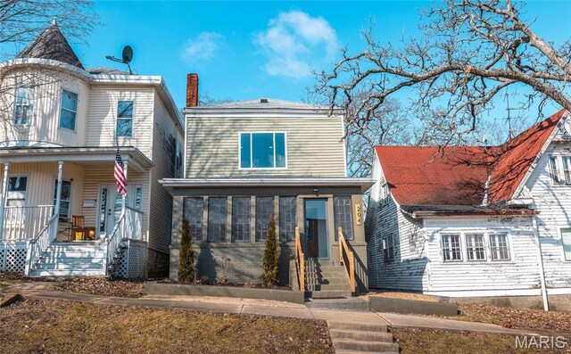 204 S 3rd St, De Soto, MO 63020 - rear view of property featuring entry steps and covered porch