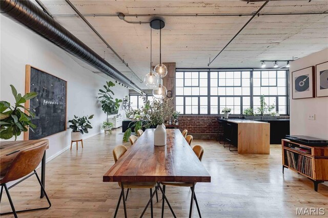 2020 Washington Ave Unit 713, Saint Louis, MO 63103 - dining room featuring light wood-type flooring and brick wall