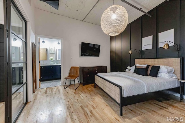 2020 Washington Ave Unit 713, Saint Louis, MO 63103 - bedroom featuring light wood finished floors and ensuite bathroom