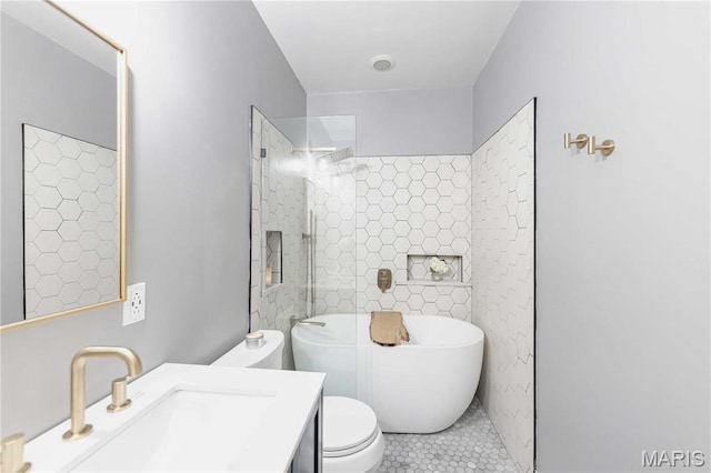 2020 Washington Ave Unit 713, Saint Louis, MO 63103 - full bathroom with a freestanding tub, tile patterned flooring, vanity, toilet, and a tile shower