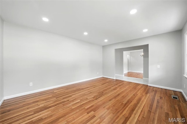 unfurnished room with light wood-style floors, baseboards, and recessed lighting