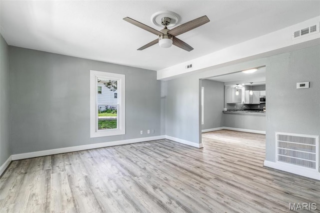 608 W Main St, Park Hills, MO 63601 - unfurnished living room featuring wood finished floors, ceiling fan, and baseboards