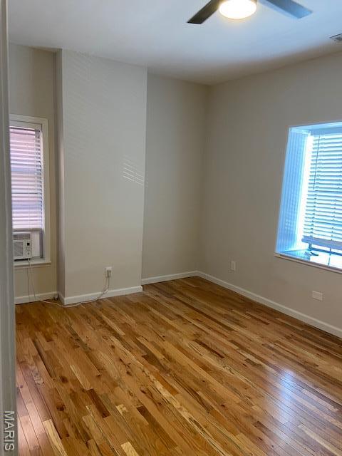 6330 Clayton Ave, Saint Louis, MO 63139 - spare room featuring hardwood / wood-style floors, a ceiling fan, baseboards, and cooling unit