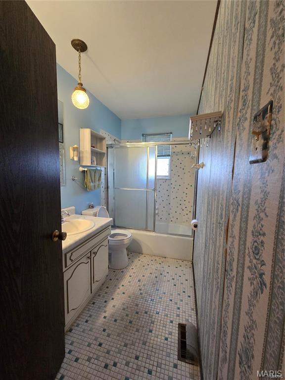 331 Rue Orleans, Bonne Terre, MO 63628 - full bathroom with vanity, toilet, and bath / shower combo with glass door