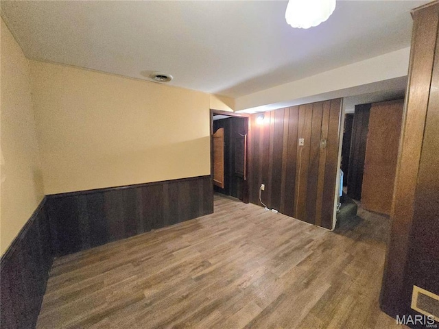 331 Rue Orleans, Bonne Terre, MO 63628 - unfurnished room featuring wood walls, wood finished floors, and a wainscoted wall